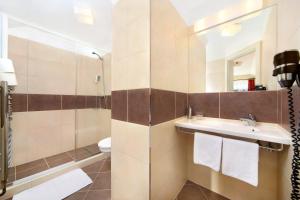La salle de bains est pourvue d'un lavabo, d'une douche et de toilettes. dans l'établissement Hotel Erika, à Špindlerův Mlýn