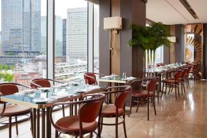 a restaurant with tables, chairs, and tables with umbrellas at Four Seasons Hotel Tokyo at Marunouchi in Tokyo