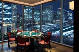 a table in a room with a view of a city at Four Seasons Hotel Tokyo at Marunouchi in Tokyo +62 photos