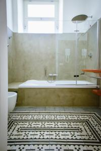 y baño con bañera y ducha acristalada. en Villa le Pigne, en Malfa