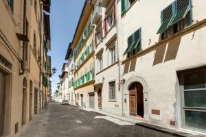 an empty street in a city with buildings at Margot Apartment by Mamo Florence in Florence