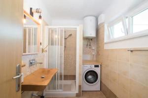 a bathroom with a washing machine and a washer at Solmar, Apartment with big terrace near nature in Portorož
