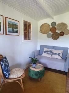 uma sala de estar com um sofá azul e uma mesa em Quinta do Benjamim - Tejo "Experience for 2, family or relax" em Praia do Ribatejo