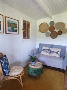 a living room with a blue couch and a table at Quinta do Benjamim - Tejo "For 2, family, nature or relax" in Praia do Ribatejo