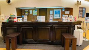 a large wooden counter with two benches in front of it at Hotel Route-Inn Shinagawa-Oimachi in Tokyo