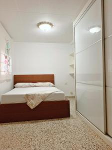 a bedroom with a bed and a walk in shower at cheap rooms in Valencia