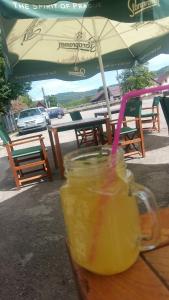 a drink in a mason jar sitting on a table at PENSIUNEA DODO in Pătîrlagele +43 photos