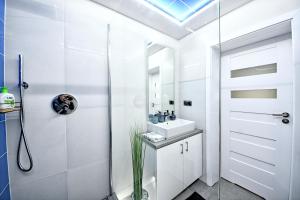 ナウェンチュフにあるBelwederの白いバスルーム(シンク、シャワー付)
