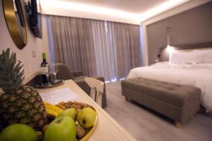 a hotel room with a tray of fruit on a table at Palacio del Sol Luxury Apartments in Nafplio