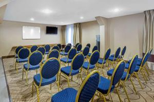 a conference room with blue chairs and a screen at Comfort Inn Hoffman Estates - Schaumburg in Hoffman Estates