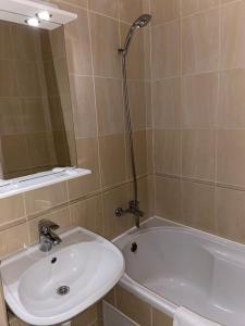 a bathroom with a sink and a bath tub at Intourist-Zakarpattia Hotel in Uzhhorod