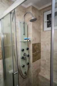 a shower with a glass door in a bathroom at Eden House in Costinesti