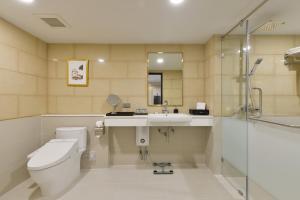 
a bathroom with a toilet, sink, and bathtub at Oakwood Hotel & Residence Bangkok SHA Plus Certified in Bangkok
