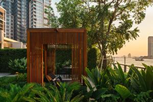 a small wooden shed in the middle of some plants at Capella Bangkok in Bangkok