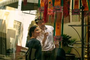 a man and a woman holding a spoon at Capella Bangkok in Bangkok