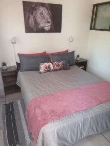 a bedroom with a bed with a lion picture on the wall at Villa Mia 15 in St Lucia