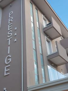 a building with a sign on the side of it at Hotel Prestige in Rimini