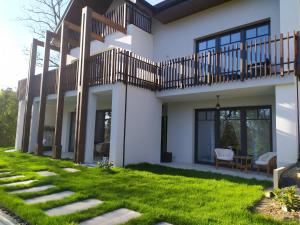a house with a green lawn in front of it at Apartamenty RÓŻANA 2 in Nałęczów