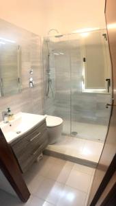 a bathroom with a shower and a toilet and a sink at Casa Giummarra al primo piano in San Vito lo Capo