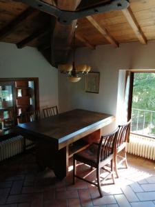 a dining room with a large wooden table and chairs at Casa di campagna appartamento in Gattaia