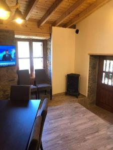 a living room with a table and a wood stove at To Spiti tou Faliari in Platanistasa