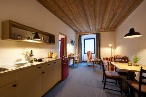 a kitchen with a table and a dining room at Historic Hotel Bircher B&B Apartments near Sterzing in Campo di Trens