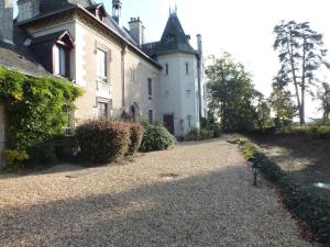 an old house with a gravel driveway in front of it at Château de Nazé Vivy-Saumur in Vivy