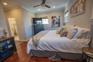 a bedroom with a bed and a television in it at Remodeled Historic House Walkable to Everything in Raleigh