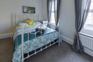 a bedroom with a bed with a blue comforter at Parker House in Salisbury