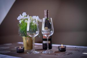 a table with two wine glasses and a bottle of wine at Hortensja Pokoje Gościnne in Krościenko