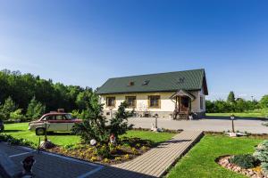 a house with a car parked in front of it at Trakai Village apartments in Jovariškės