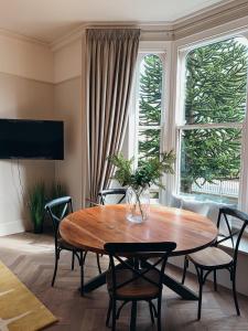 a living room with a wooden table and chairs at The Garden Room YORK in York