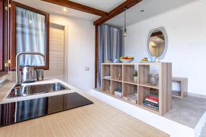 a kitchen with a sink and a mirror at La stanza di Vali in Sperlonga +38 photos