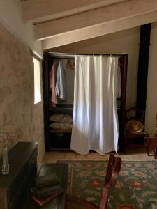 a room with a closet with a white curtain at Can Peñes in Port d’Andratx