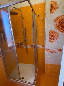 a shower in a bathroom with yellow tiles at La terrazza sullo Jonio in Roccella Ionica