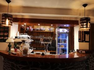 a bar in a restaurant with a counter with wine glasses at Motorest SKI Čertovica in Vyšná Boca