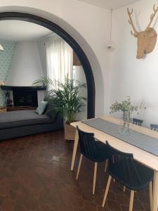 a living room with a table and a couch at Casa Olalla in Mijas