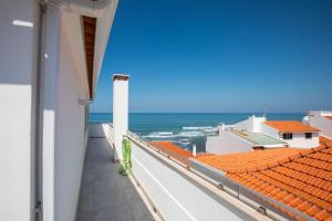 a view of the ocean from the balcony of a building at Parati Apartments in Ericeira