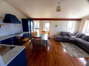 a living room with a couch and a table at Cliffs View Self Catering @ Limestone Lodge in Doolin