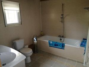 a bathroom with a tub and a toilet and a sink at Gites Luzy Morvan Bourgogne in Luzy