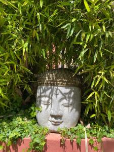 a large stone statue with a plant in it at toctoctoc lisboa in Lisbon +187 photos