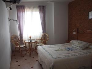 A bed or beds in a room at Hostal Yuste