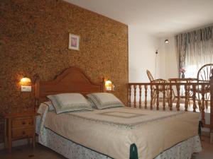A bed or beds in a room at Hostal Yuste