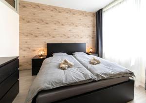 a bedroom with a large bed with two pillows on it at Gesto Apartments in Prague