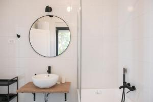 a bathroom with a sink and a mirror at Central rooms in Šibenik