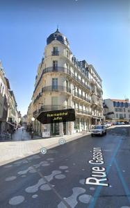 a building with a sign on the side of a street at T2 bis quartier château de Pau in Pau