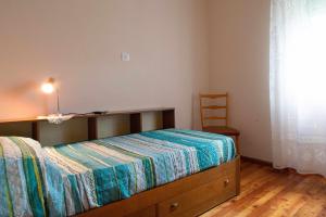 A bed or beds in a room at Appartamento Marconi 35 Pergine Valsugana