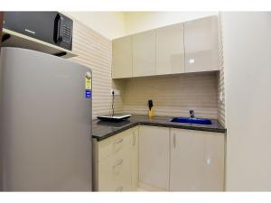 a kitchen with a refrigerator and a sink at BluO Studio1 Golf Course Road, Gym, Balcony Garden in Gurgaon