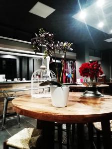 a table with a white vase with flowers on it at Hotel Sereno in Sestri Levante