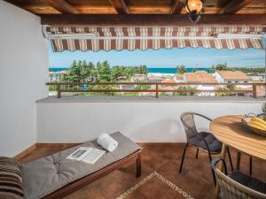 a room with a couch and a table with a view of the ocean at Apartments Špadići in Poreč